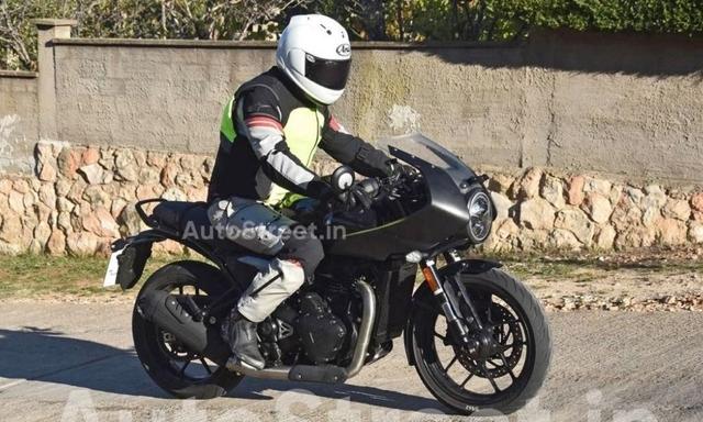 New spy shots reveal that Triumph is working on a new cafe racer based on the Speed 400 with a retro bubble fairing and this could be the Triumph Thruxton 400 in the works 

