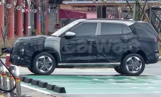The upcoming Creta Electric was recently spotted wearing camouflage while parked at a charging station in South Korea revealing new details.
