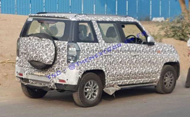 Mahindra is giving the TUV300 a mid-life update and the new set of spy pictures reveal the changes made to its rear and side.