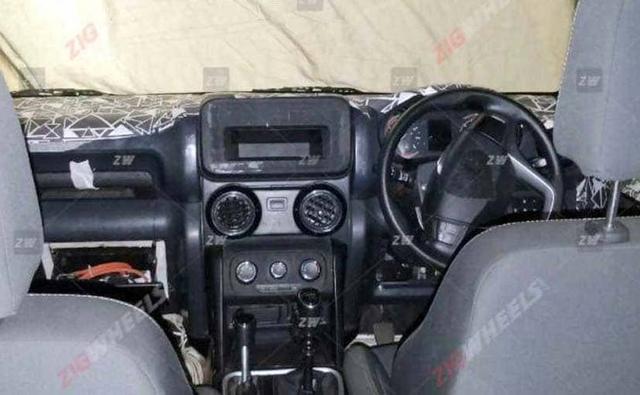 The spy images are of the 4x4 Mahindra Thar and the four-wheel drive engage lever is clearly visible alongside the gear lever.