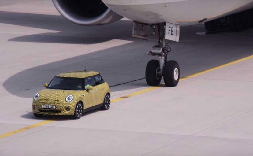 Mini Cooper SE Electric Teased Towing An Aircraft