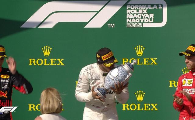 Lewis Hamilton won the 2019 Formula 1 Hungary Grand Prix beating pole-sitter Max Verstappen after a high octane battle. With four laps to go, the Mercedes driver passed Verstappen to claim his seventh win of the year. The Red Bull racer finished 17.796s behind the race leader while Ferrari's Sebastian Vettel finished third over a minute behind Hamilton, taking the podium finish from teammate Charles Leclerc.