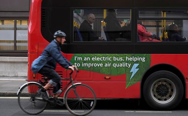Britain said on Tuesday it would complete a plan next year to achieve net zero emissions from all forms of transport, as climate change activists targeted the transport ministry.