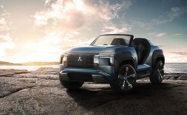 The MI-Tech concept is designed to be a dynamic buggy-type vehicle. It shows off a light blue body colour and a secondary copper colour in a motor coil motif on the grille, inner wheels, and interior.
