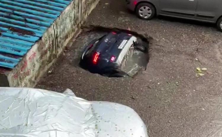A 26-second video shows the hood and front wheels of the car enter the sinkhole first, and it took a couple of seconds for the entire car to fell into the water.