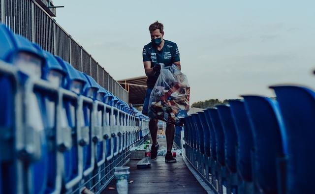 After early retirement in the 2021 British GP, Aston Martin driver Sebastian Vettel was seen in the grandstands clearing litter with fans, setting the right example.
