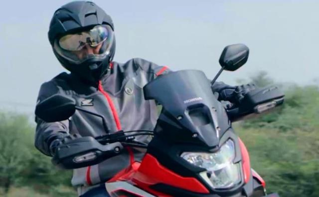 The new teaser video gives a glimpse of the tall-set handlebar on the upcoming Honda adventure motorcycle as well as the step-up style seat and a two-piece pillion grab rail.