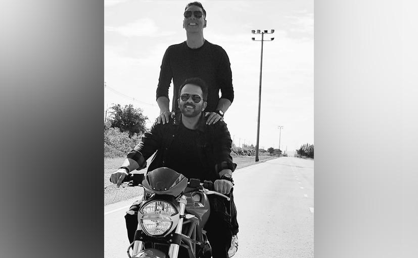 Actor Akshay Kumar has posted a photo on his social media handle showing him and filmmaker Rohit Shetty sharing a Jai-Veeru moment on a Ducati Monster. The photo seems to have been taken behind the scenes during the filming of their upcoming movie Sooryavanshi.
