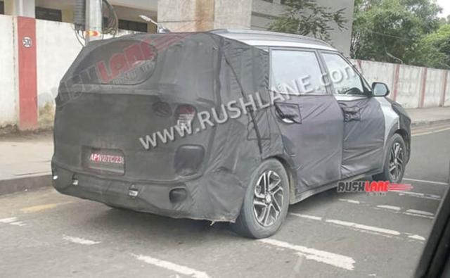 A new prototype model of Kia's upcoming 3-row vehicle was spotted testing in India, and the badging on the car's steering wheel reveals that the vehicle will be called Kia Carens.