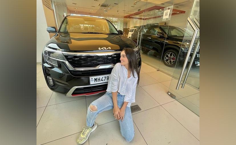 Tanya Sharma poses with her new brand new Kia Seltos GTX Plus SUV