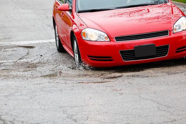 Driving on a road filled with potholes can give you a feeling of what it's like to drive on the moon. They have caused considerable damage to the car.