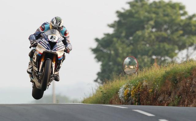 Michael Dunlop's victory in the Superbike race comes three days after his Tyco BMW teammate Dan Kneen died during qualifying at the Isle of Man.