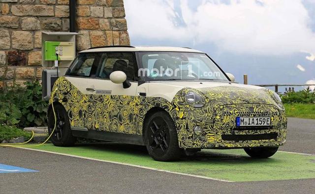 A partially camouflaged test mule of MINI's upcoming electric car was recently spotted while charging up. The latest spy images also give us a closer look at the cabin of the new Electric MINI, and images tell us that both from the outside as well inside, the car will share visual similarities with the standard 3-Door hardtop MINI.