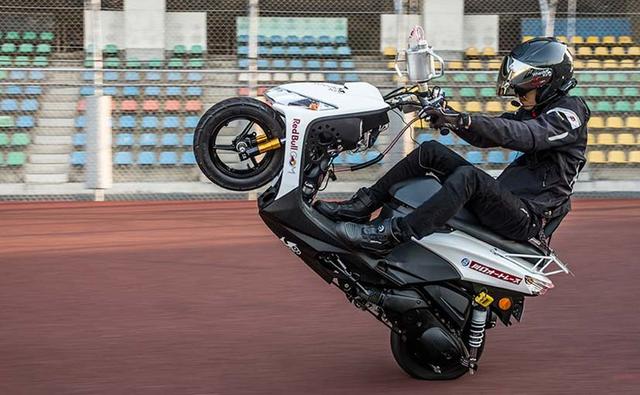 Japanese scooter rider Masaru Abe rode over 13 hours on his Yamaha Jog scooter, covering a distance of over 500 km to set a new record for the world's longest continuous wheelie
