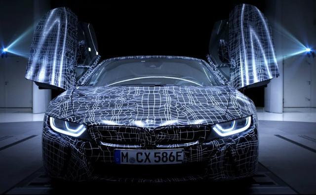 BMW has officially teased the i8 Roadster and has confirmed that it will be hitting the showrooms sometime in 2018. The hybrid sportscar might also get a few cosmetic updates along with more power for the engine too.