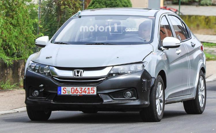 The Honda City is one of the most popular cars in India, especially in its segment. Essentially the sedan version of the Jazz (or the Fit as it is known internationally), a strange test mule of the City has been spied undergoing testing in Europe recently. The said test mule as you can see in the pictures is not just the standard city though but is longer than the usual car with a few inches of extra metal added to the rear doors along with protrusions on the rear bumper and a humped bonnet.