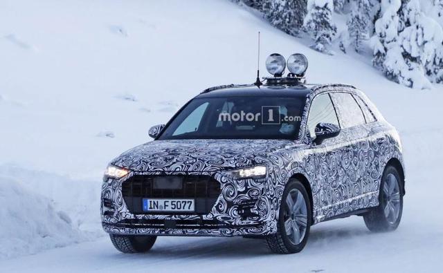 A new prototype model of the upcoming next-generation Audi Q3 SUV has been spotted undergoing cold weather testing. This time around we have come across spy images of what appears to be a lower-spec model of the new Audi Q3, as the test mule is seen sporting halogen headlamps with the conventional, integrated turn signal indicators, instead of the new sweeping LED turn signals.
