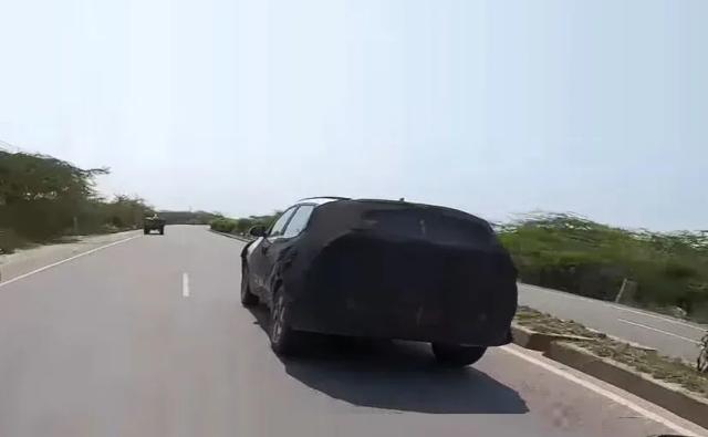 The upcoming Kia Sonet subcompact SUV has been spotted testing on the Indian roads as the Indian government has eased the lockdown restrictions. The production-ready version of the Sonet SUV was captured on camera by DCV bikes while testing in Haryana. The test mule can be seen heavily camouflaged concealing the details, however, the overall boxy silhouette, sharply raked window-line and dual-tone alloy wheels revealed its identity. The carmaker is expected to launch the Sonet subcompact SUV in India during the festive season.