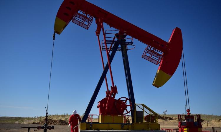 Oil prices rose nearly 2% in volatile trading, bouncing off multi-month lows touched last week, as positive economic data from China and the United States fed hopes for demand despite nagging fears of a recession.
