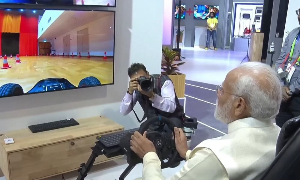 Prime Minister Narendra Modi Remotely Drives Car In Sweden From India At India Mobile Congress 2022 Prime Minister Narendra Modi Remotely Drives Car In Sweden From India At India Mobile Congress 2022